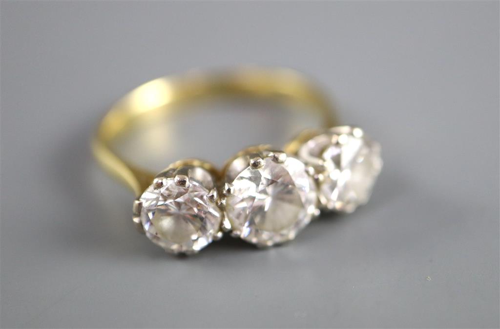 A modern 18ct gold and three stone brilliant cut diamond ring,